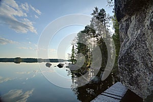 Wooden bridge leading around rock cliff at Faangsjoen in Sweden