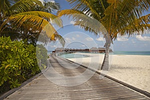 Wooden bridge leading to the bungalows, a beautiful place in the Maldives