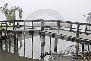Wooden bridge in a misty morning