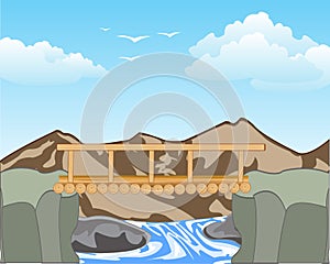 Wooden bridge in mountain on tempestuous river