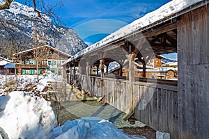 Wooden bridge over Loisach river in Garmisch Partenkirchen in winter