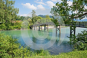 Wooden bridge over Mangfall river, beautiful bavarian landscape in june, tourist resort Gmund