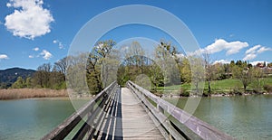 wooden bridge over mangfall river, spa town gmund at lake tegernsee