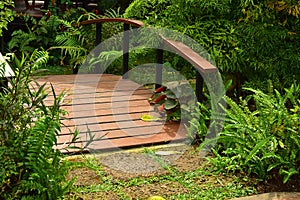 The Wooden Bridge over the pond with Flower Garden