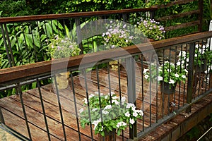 The Wooden Bridge over the pond with Flower Garden