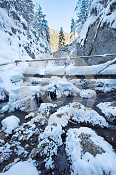 Wooden bridge over Prosiecanka creek in Prosiecka dolina gorge during winter