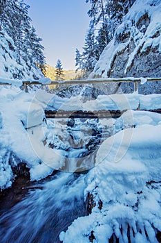 Wooden bridge over Prosiecanka creek in Prosiecka dolina gorge during winter