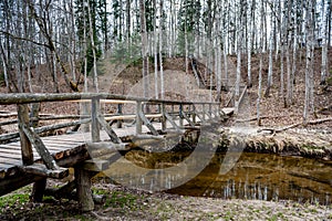 Wooden bridge over the river leading to the Vilce Nature Park.