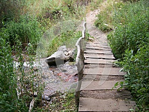 Wooden bridge over the river for the passage in the mountains