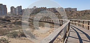 Wooden bridge over sheltered sandy beach photo