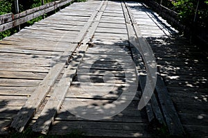 Wooden bridge over a small river. so that the cars only run in a certain corridor, the boards are in two lanes for wheelbases. boa