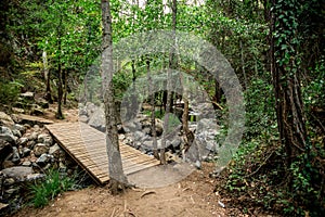 A wooden bridge over a small river on a way to Caledonia waterfall near Platres