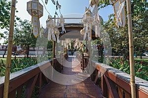 Wooden bridge with paper lanterns in Chiang Mai during the Loi Krathong Festival