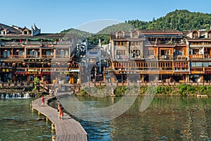 Wooden bridge path over Tuo Jiang river in Feng Huang