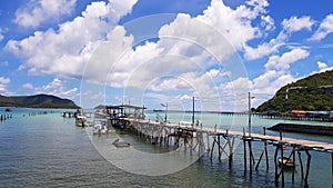 Wooden bridge pathway for group of people, tour, tourist walk to get in speedboat and longtail boat to take trip on sea go to isla