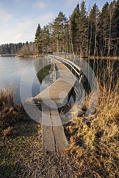 Wooden bridge pathway over water surface in Mellonlahti, Imatra Finland