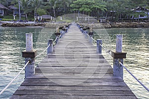 Wooden bridge pier boat in the sea and the bright sky