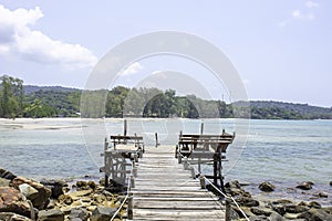 Wooden bridge pier boat in the sea and the bright sky at Koh Kood, Trat in Thailand