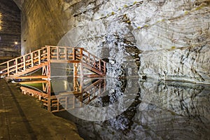 Wooden bridge reflexion in underground salt mine