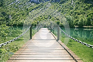 Wooden Bridge in a river of Pirineos photo