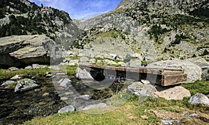 Wooden Bridge in a river of Pirineos photo