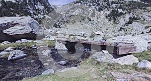 Wooden Bridge in a river of Pirineos photo