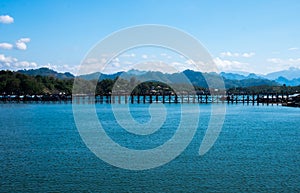 The wooden bridge stretches across the river