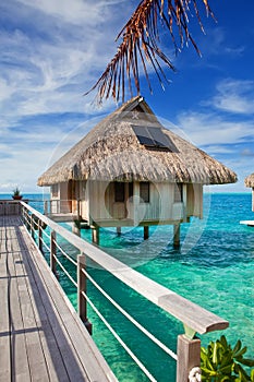 The wooden bridge to a hut over water at the ocean