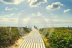 Wooden bridge to the sea. The sky with beautiful clouds. Recreation.Travel.