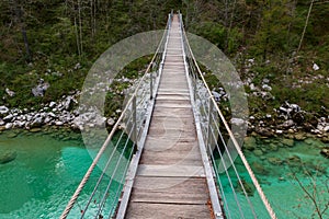 Wooden bridge the turquoise green Soca river