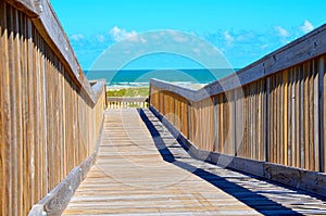 Wooden bridge walk to the ocean beach