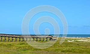 Wooden bridge walk to the ocean beach