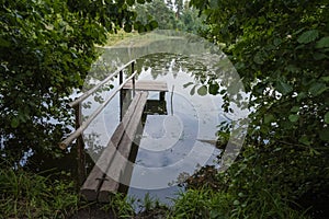 Wooden bridges leading into the river among green bushes