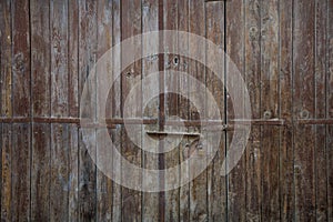 Wooden brown aged door, rusty latch and padlock. Close up, details