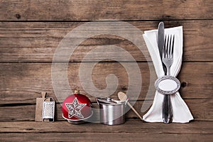 Wooden brown christmas background with cutlery and a white napki