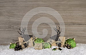 Wooden brown christmas background with reindeer, balls and gifts