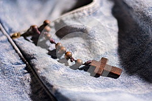 Wooden brown cross with rosary crown