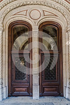 Wooden brown Front Door of a Luxurious house. Doors with glass and forged window grille