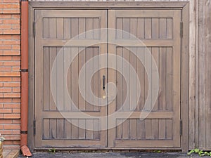 Wooden brown gate in the street