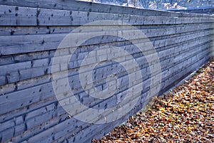 Wooden brown opaque fence with horizontally attached planks. fence as protection against noise from cars driving on the street. au