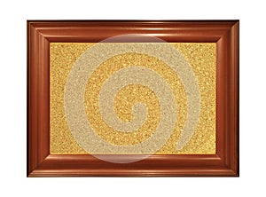 Wooden and brown ornamental frame with rectangular beige cork board