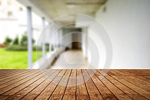 Wooden brown table top against the blurred corridor, passage and courtyard of the house .For product display montage or design is