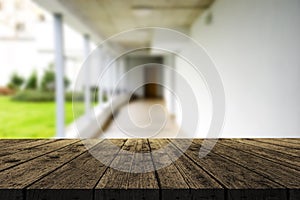 Wooden brown table top against the blurred corridor, passage and courtyard of the house .For product display montage or design is