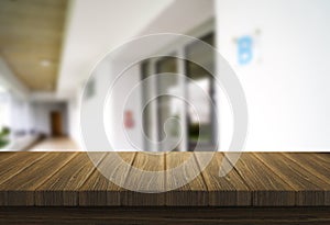 Wooden brown table top against the blurred corridor, passage and courtyard of the house .For product display montage or design is