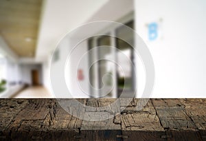 Wooden brown table top against the blurred corridor, passage and courtyard of the house .For product display montage or design is