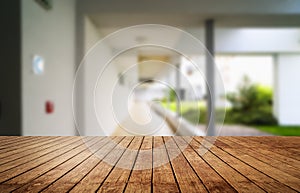 Wooden brown table top against the blurred corridor, passage and courtyard of the house .For product display montage or design is