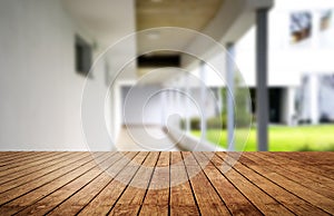 Wooden brown table top against the blurred corridor, passage and courtyard of the house .For product display montage or design is