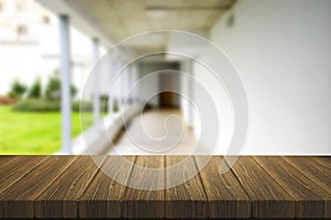 Wooden brown table top against the blurred corridor, passage and courtyard of the house .For product display montage or design is