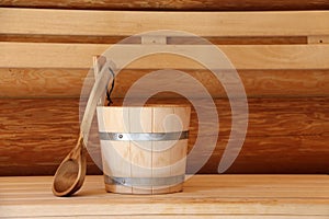 Wooden bucket in a bath on a wooden surface