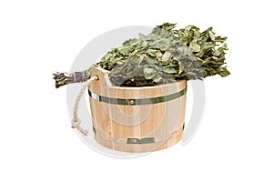 Wooden bucket with birch broom isolated on white background